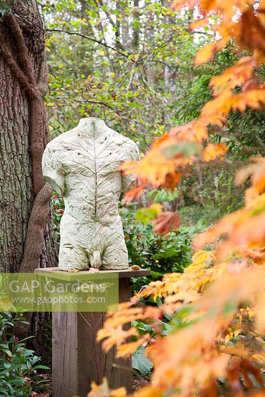 Torso of Leaves by Stephen Duncan made from marble, concrete and polymer. The Hannah Peschar Sculpture Garden designed by Anthony Paul, Landscape Designer