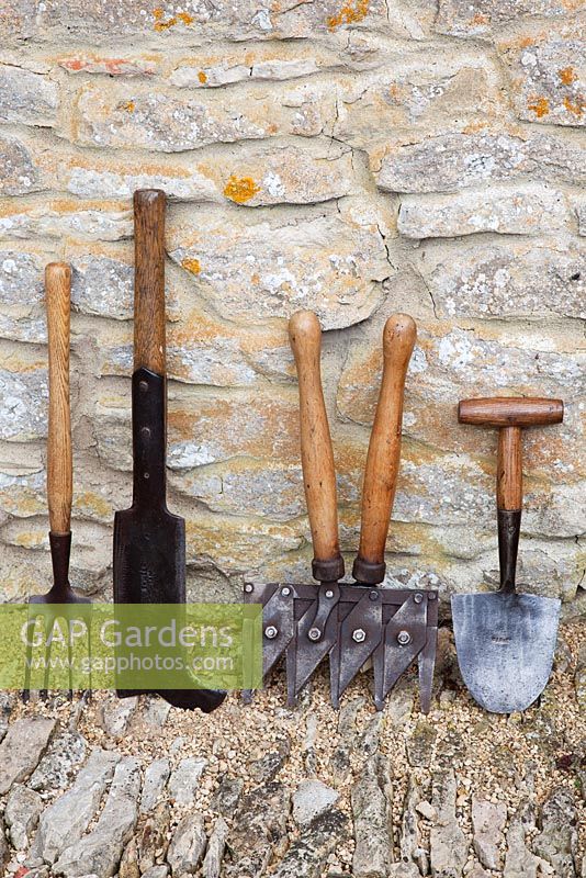 Antique gardening tools. From left, long handled hand fork, Yorkshire billhook, Astor shears and strawberry planting spade