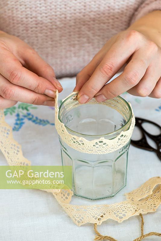 Decorating glass jars for garden posies step by step.  Measuring cotton lace to decorate a glass jar.