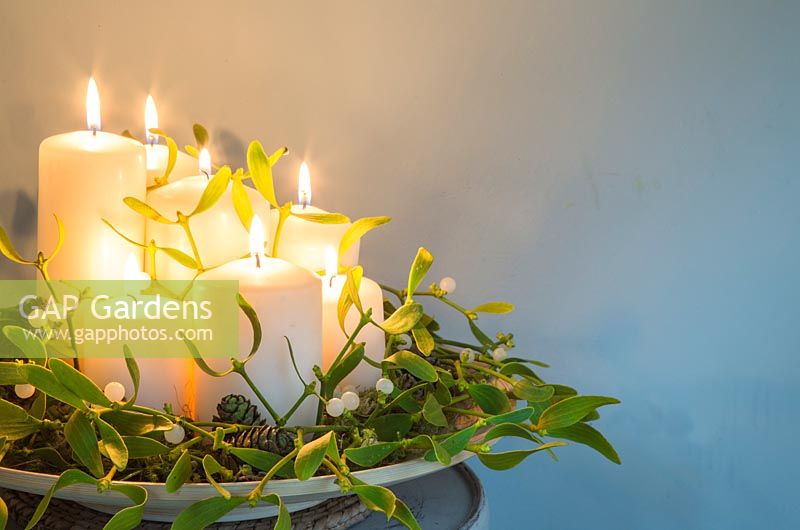 Candles decorated with Mistletoe, Pine cones and Alder. 