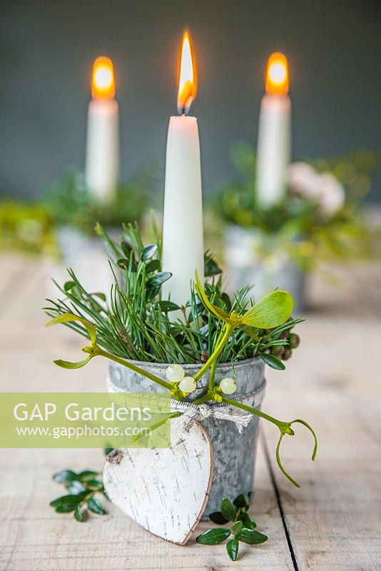 Candle holders decorated with Mistletoe, Birch hearts, Pinus and Hedera.