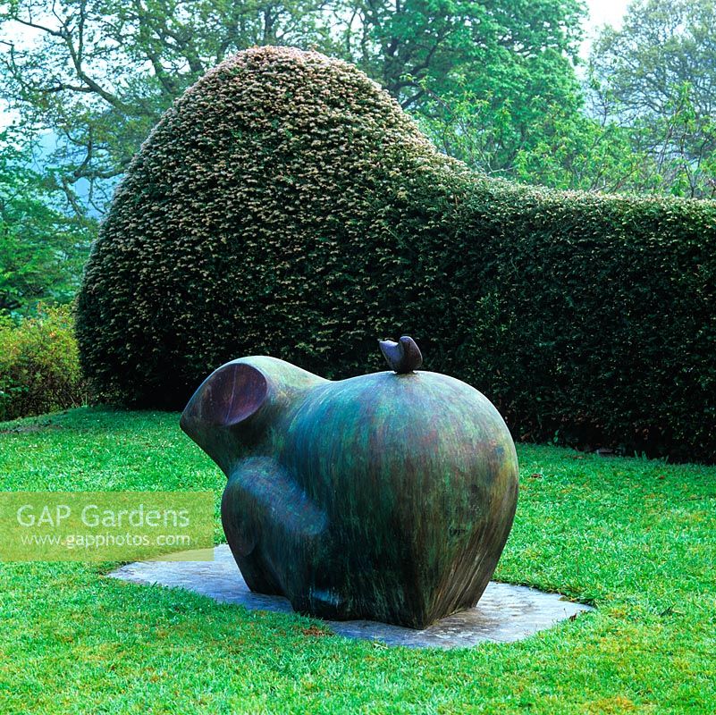 'Sheep' by Bridget McCrum - a bronze inspired by a piece in an Algiers museum, its curving line echoed by yew hedge behind.