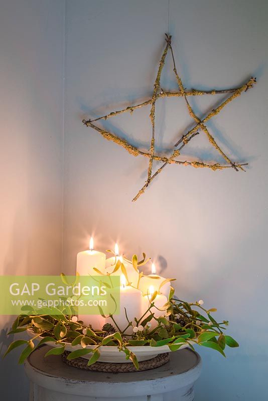 A festive star made from Prunus with Lichen cuttings, accompanied with Candles and Mistletoe. 
