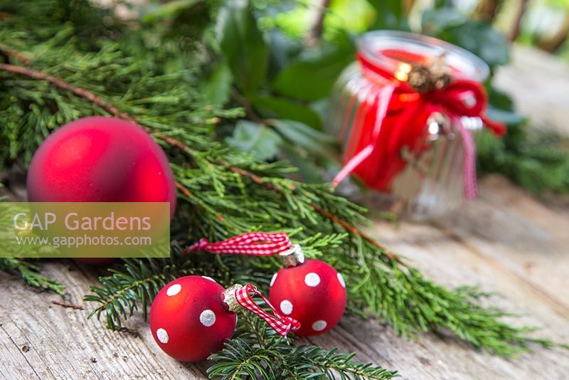 Red polkadot baubles with cedar and yew foliage