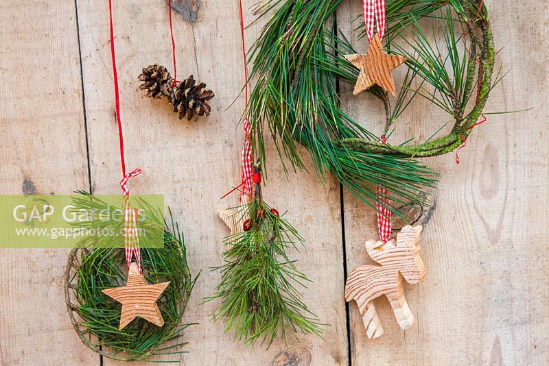 A variety of Evergreen wreaths with wooden stars, Pine cones and a reindeer