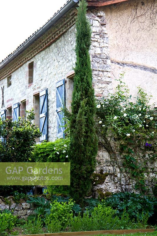 Rose clad stone cottage.  Part of the property and garden at Domaine de Chatelus de Vialar.  