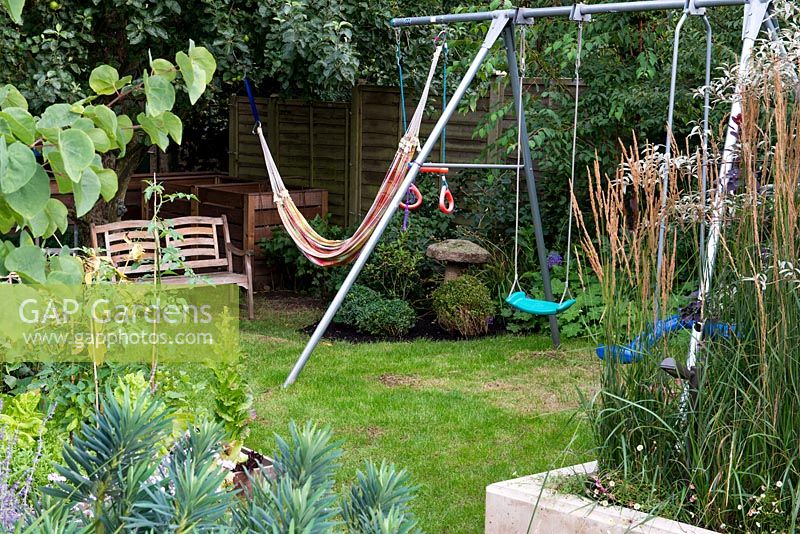 A swing and hammock in the children's play area hidden at the bottom of the garden.