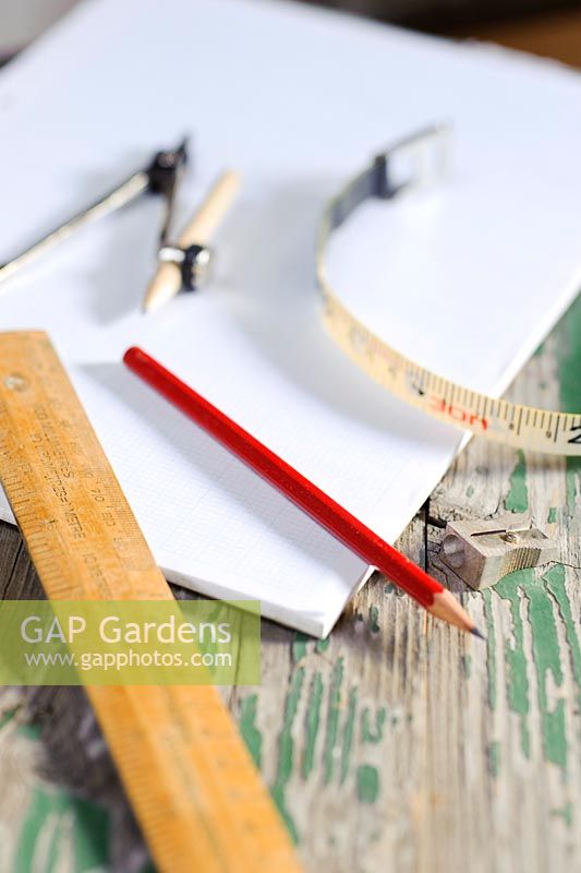 Tools for garden surveying and planning. Ruler, graph paper, pencil, compass and tape measure