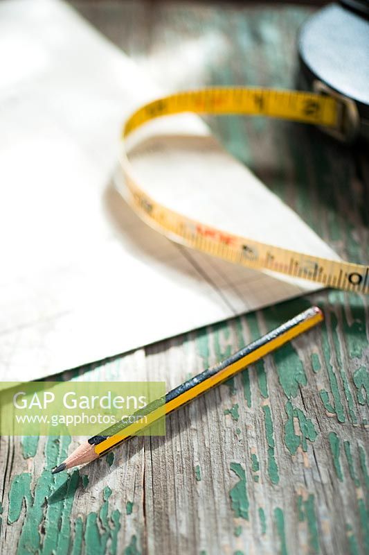 Tools for garden surveying and planning. Squared paper, pencil and tape measure