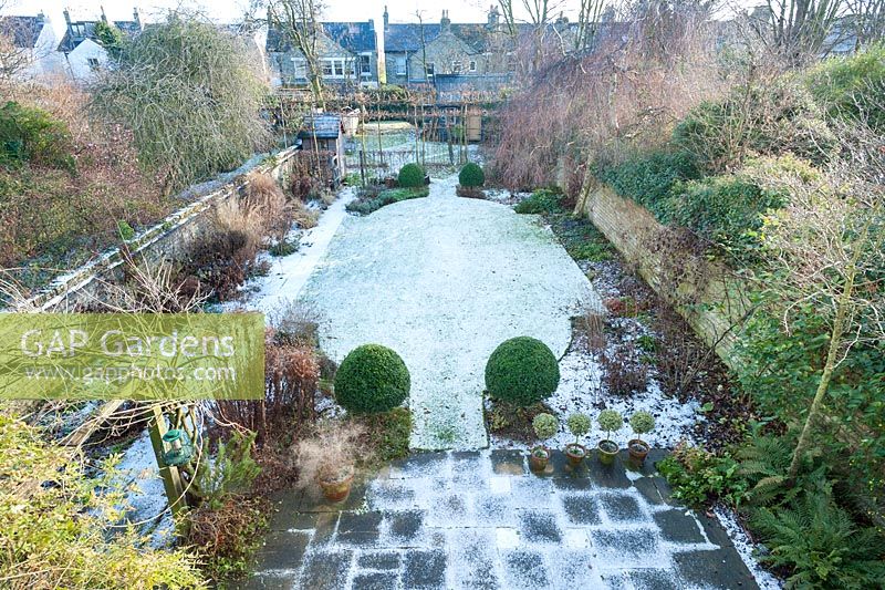 Formal town garden with snow