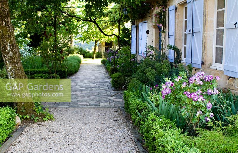 Early summer at the front garden and path at Domaine de Cambou, Verfeil, Haute-Garonne, Midi Pyranees, France.