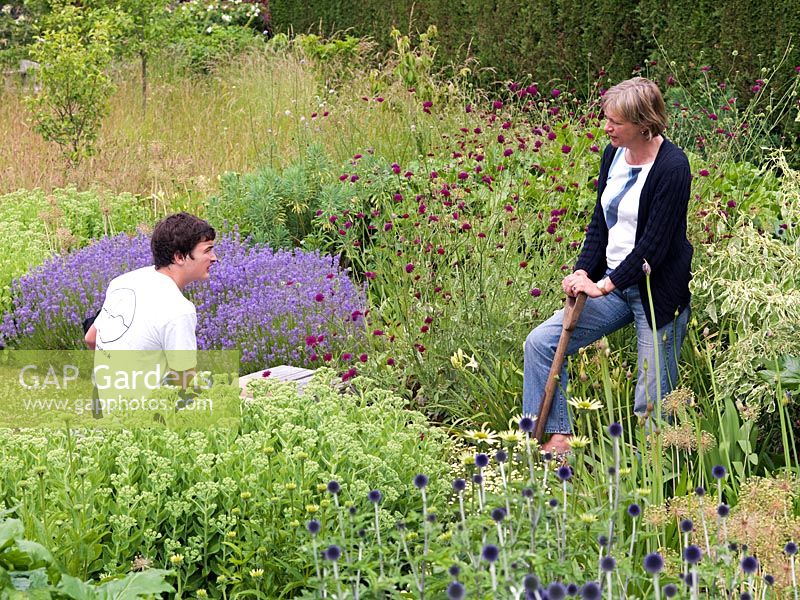Julia Whiteaway chats to her son, William, in her one-acre country garden where the planting is design to meld with the wider, rural landscape.
