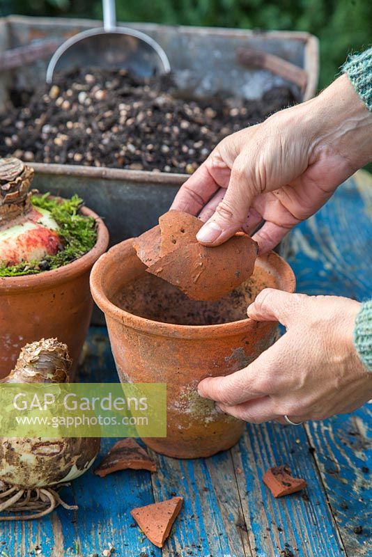 Adding crocks to pots to assist with drainage