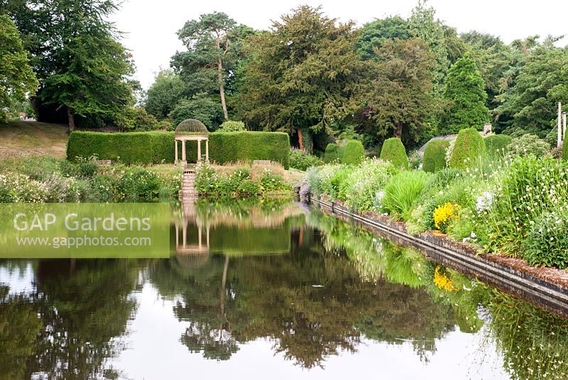 The Long Pond and Border at Forde Abbey in early Summer with view to Ionic Temple.