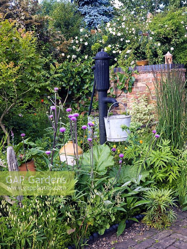 Victoria water pump in mixed vegetable and flower garden