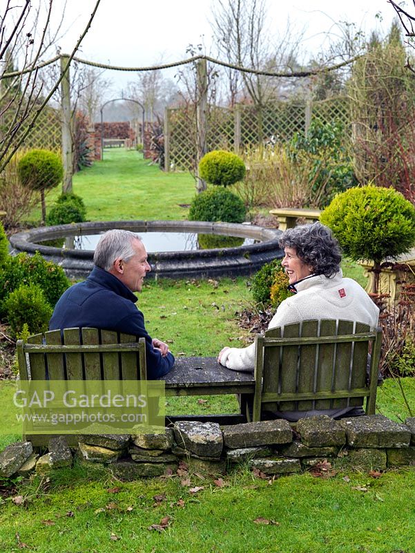 Mark and Jackie Porter sit overlooking their formal rose garden