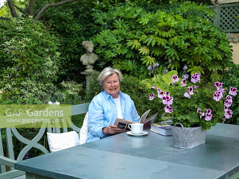 Esme Auer sitting at garden table