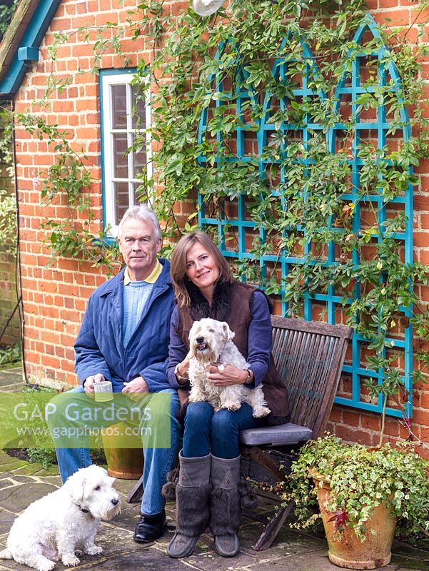 John and Kate Bolsover in their garden with their dogs, Washington and George.