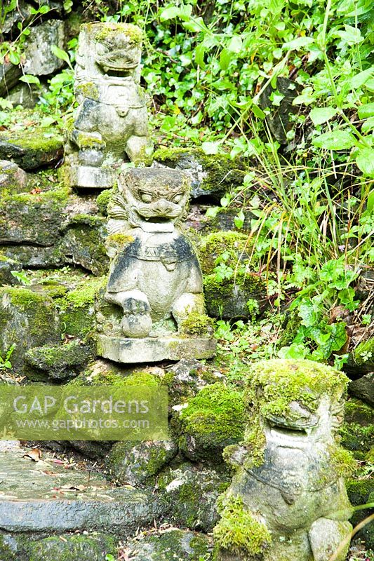 Guardian lions below a To-Doro, stupa lantern. The Japanese Garden and Bonsai Nursery, St.Mawgan, nr Newquay, Cornwall