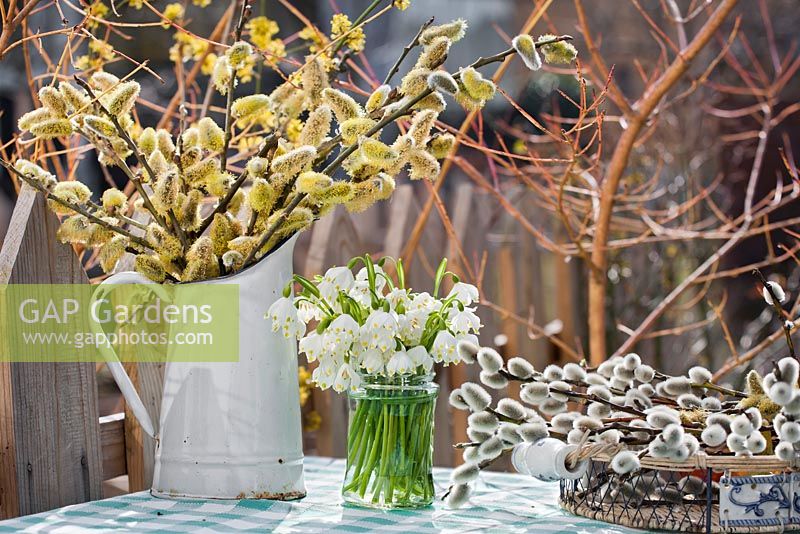 Spring arrangements with catkins and snowflakes.