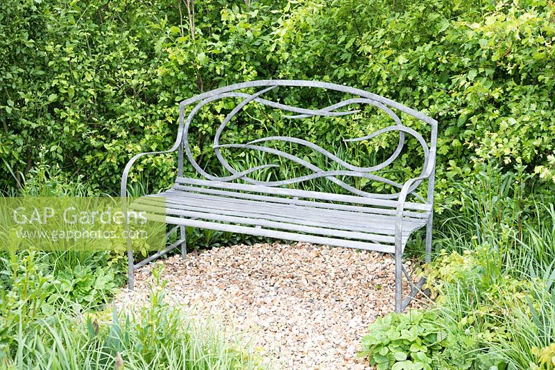 Metal bench surrounded by natural planting - Let's Get You Home garden, RHS Malvern Spring Festival 2015