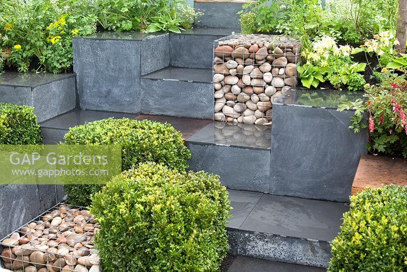 Ooooh ...it makes me wonder. Malvern Spring Gardening Show 2014, inspired by the classic Led Zeppelin song 'Stairway to Heaven', and the Giant's Causeway rock formation, with squares of buxus, gabions and planting - Designer: Teresa Rham - Sponsor: The Dingle Nurseries and Gardens