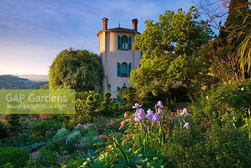 Villa Fort France, Grasse, France. View of the villa with irises in foreground 