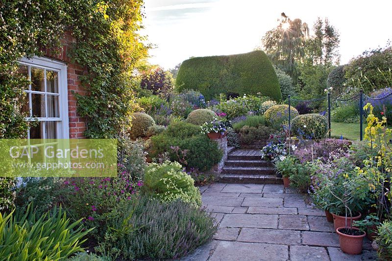 Sunken patio with container planting at Hambledon House Hampshire.