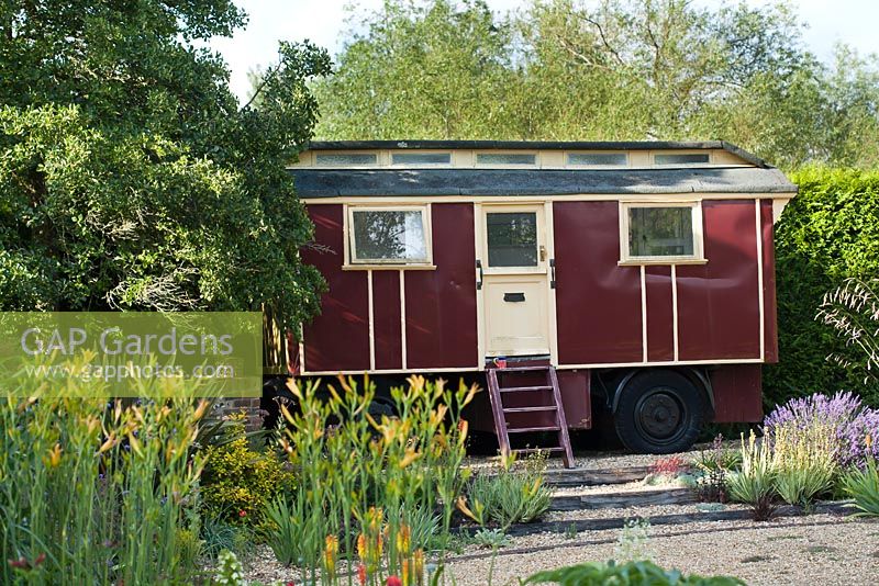 A vintage caravan serves as an unusual summerhouse