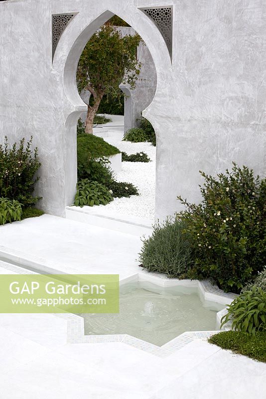 White marble floor with star shaped rill water feature. The Beauty of Islam. RHS Chelsea Flower Show, 2015