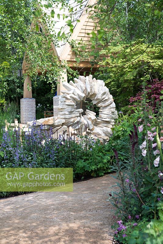 The M and G Garden - The Retreat. Purbeck stone sculpture through cottage style planting 