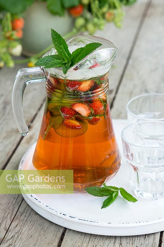 Jug of Pimm's and lemonade with Mint, Cucumber and Strawberries added to the jug