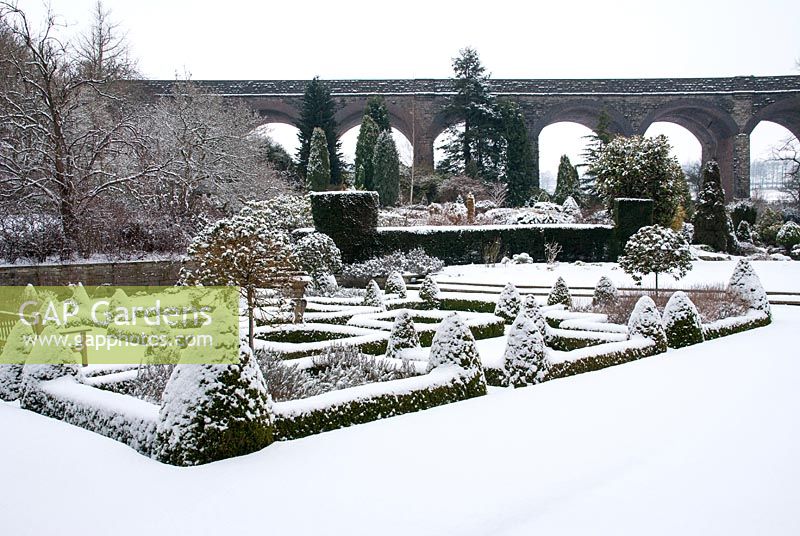 The parterre at Kilver Court in Somerset, covered in snow, viaduct in background