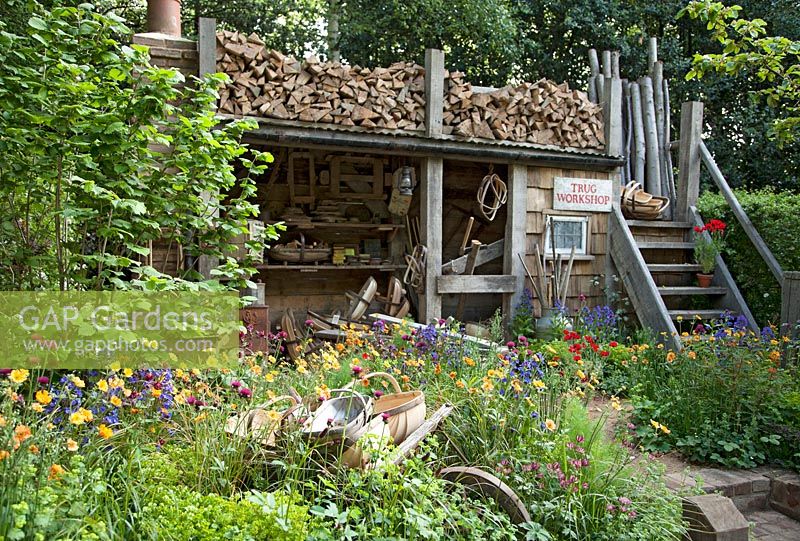Trugmaker's traditional timber workshop and cottage garden plants. The Trugmaker's Garden - RHS Chelsea Flower Show 2015 