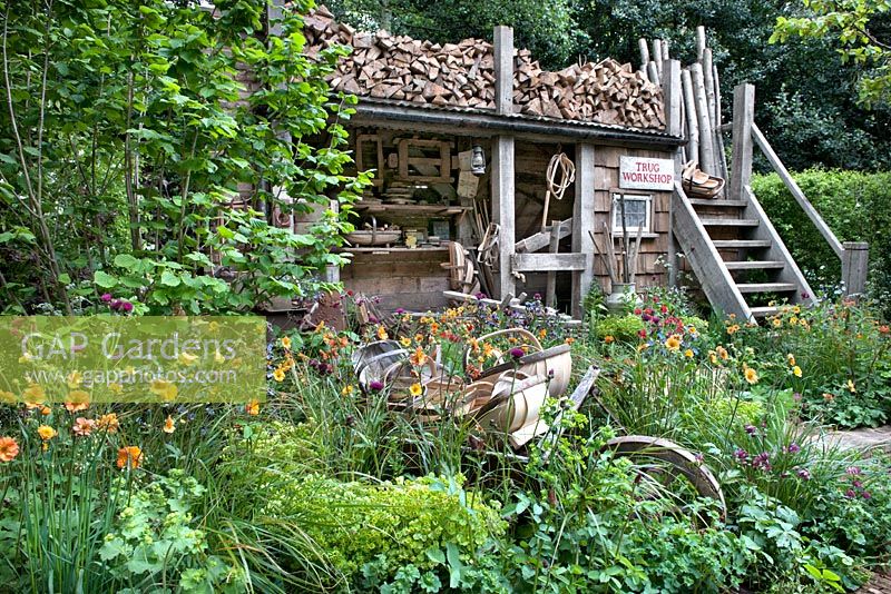 A Trugmaker's Garden. Traditional timber workshop and cottage garden plants. RHS Chelsea Flower Show, 2015