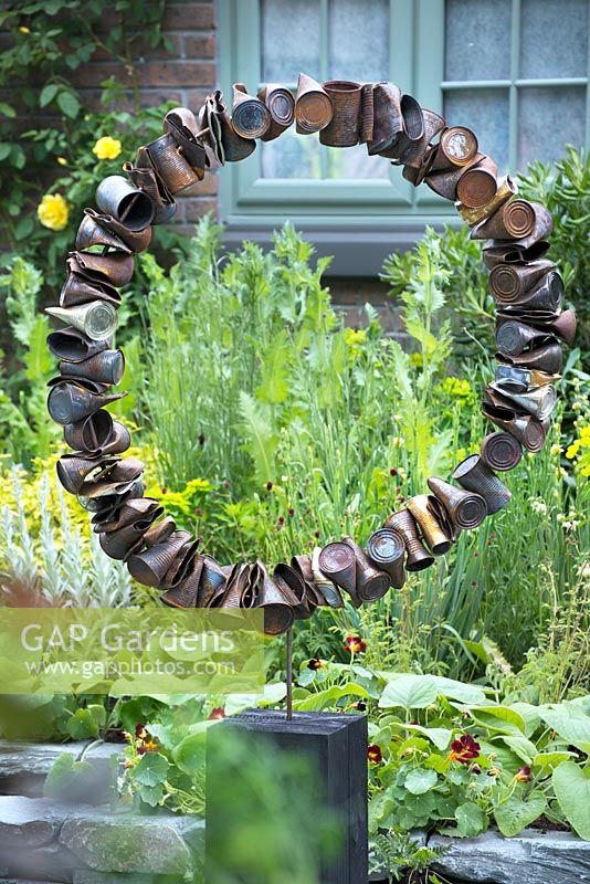The Great Chelsea Garden Challenge. Circular sculpture made from rusted old steel cans.