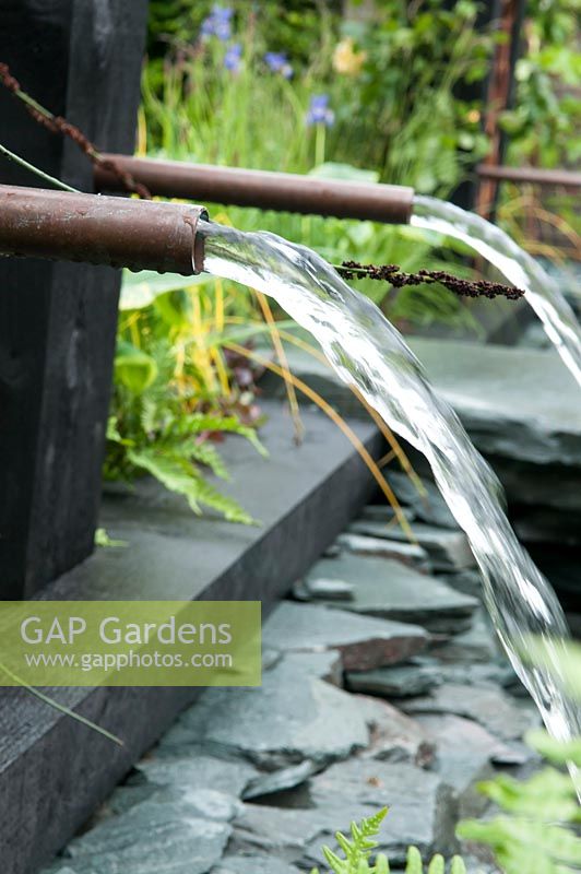 Ebb and Flow of water through copper piping  RHS 'Great Garden Challenge' Garden. RHS Chelsea Flower Show, 2015.