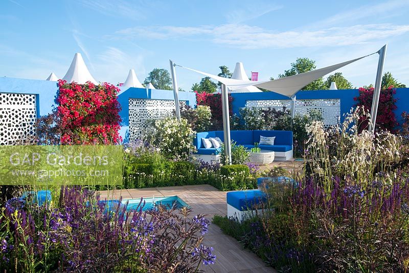 Sheltered Mediterranean garden with living wall, curved seating and canvas sail - Noble Caledonia: Spirit of the Aegean, RHS Hampton Court Palace Flower Show 2015