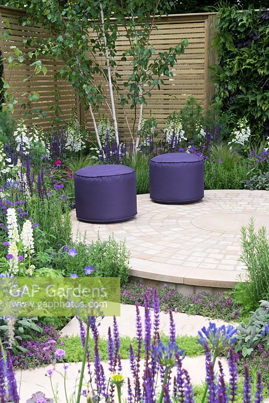 Purple stools on circular paving - The Wellbeing of Woman Garden, RHS Hampton Court Palace Flower Show 2015 - Design: Wendy von Buren, Claire Moreno, Amy Robertson