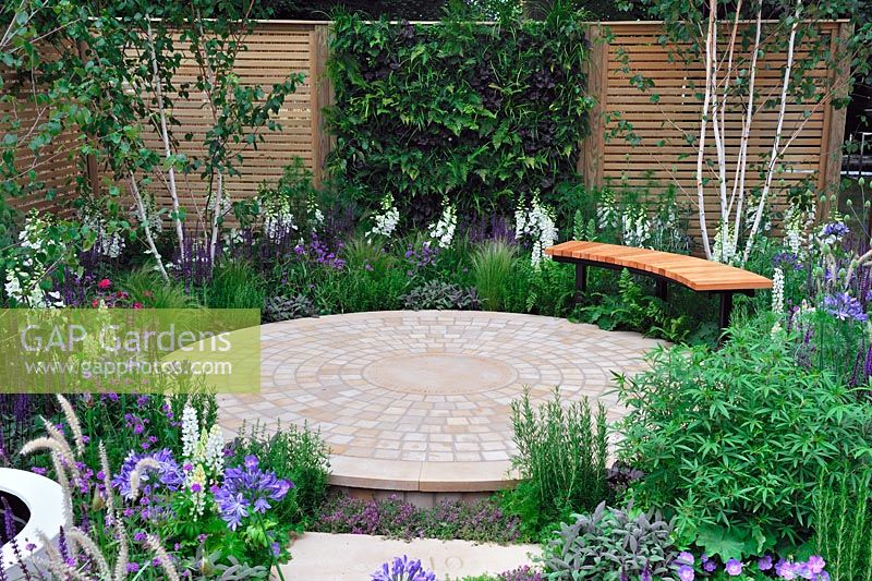 Circular patio and garden seat, timber fence and living wall panel - The Wellbeing of Women Garden, RHS Hampton Court Palace Flower show 2015