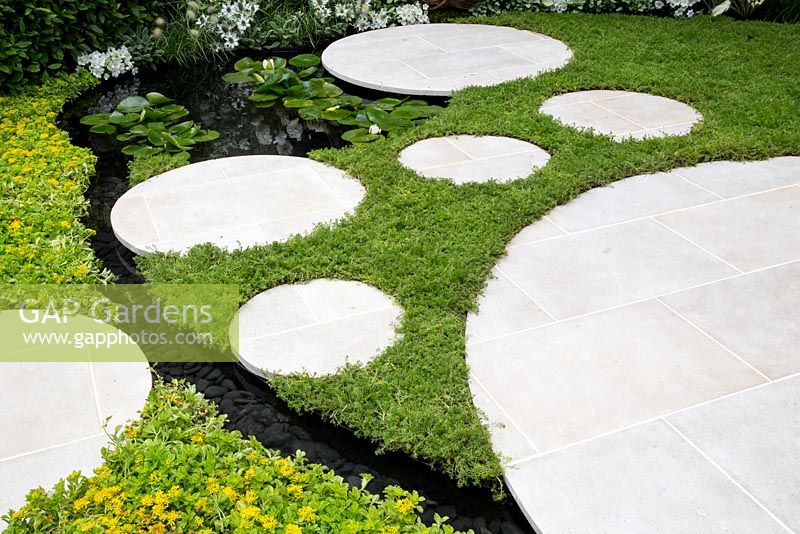 Living Landscapes: City Twitchers Garden - Chamomile nobile 'Treneague' lawn with stone stepping stones and patio, small pond with water lilies and a rill, sedum ground cover - Designer CouCou Design, Sarah Keyser - Sponsor Living Landscapes - RHS Hampton Court Flower Show 2015 - awarded Silver gilt