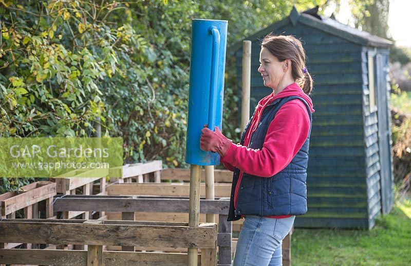Use a post driver to secure your wooden stakes firmly into the ground