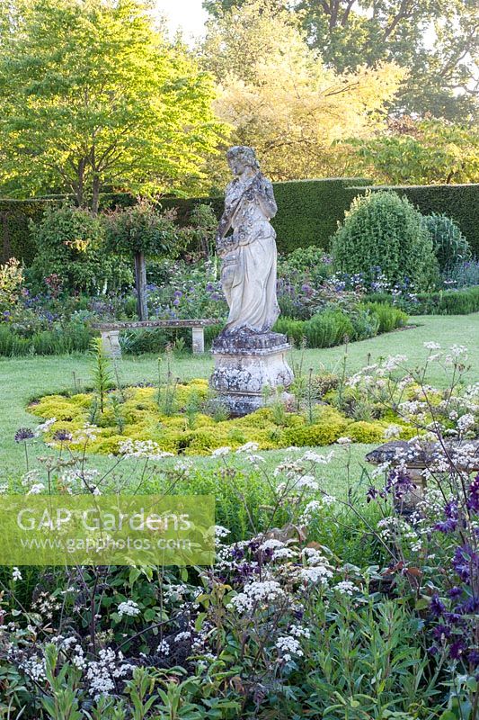 Statue in formal garden in early summer - Helmingham Hall, Suffolk