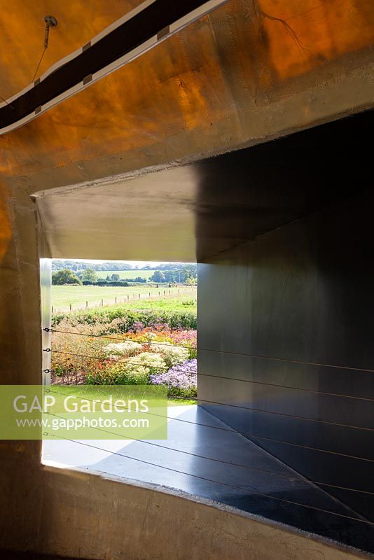 View onto the Oudolf Field from within the Ruddock Pavillion. Hauser and Wirth, Bruton, Somerset. Planting design by Piet Oudolf.