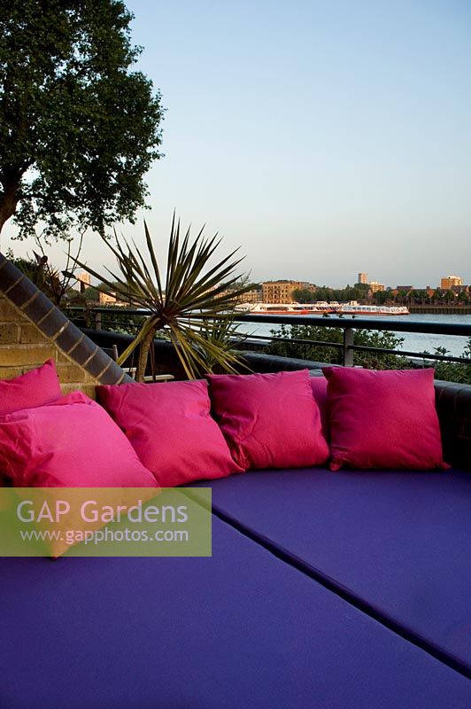 Contemporary balcony overlooking the Thames at Wapping with colourful soft furnishing 