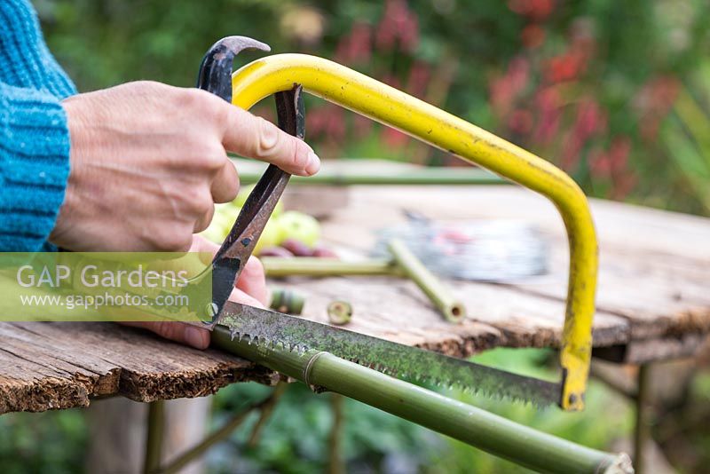 Cutting the bamboo to the correct lengths that match the sides of the wooden platform