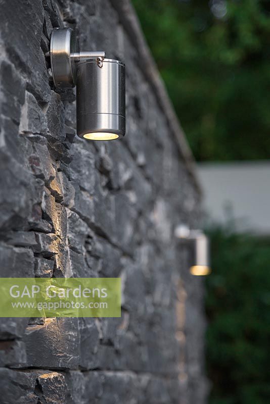 View of lighting features against a dry stone slate wall