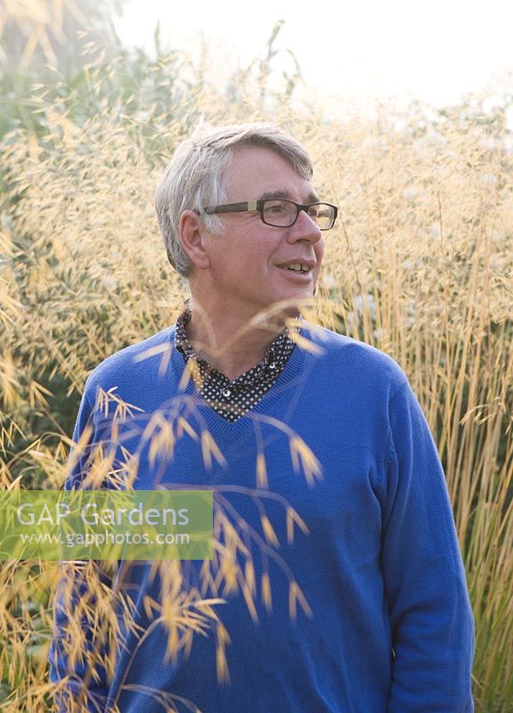 Garden designer John Hoyland mongst stipa gigantea. Glyndebourne, East Sussex