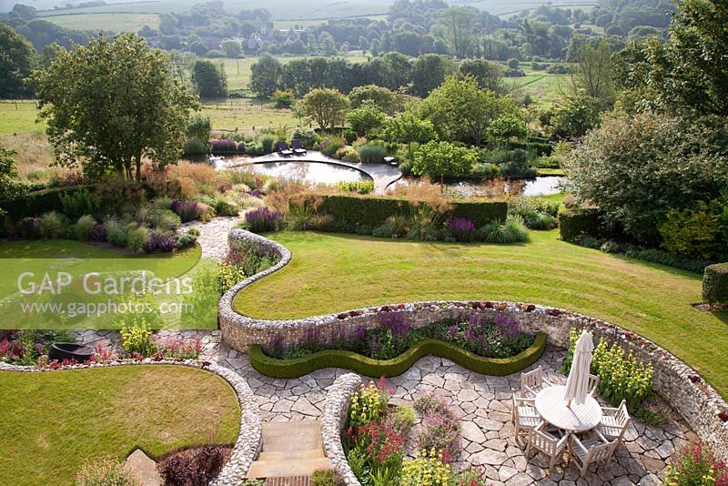 View from above of landscaped gardens and countryside views beyond. Follers Manor, Sussex. Designed by: Ian Kitson