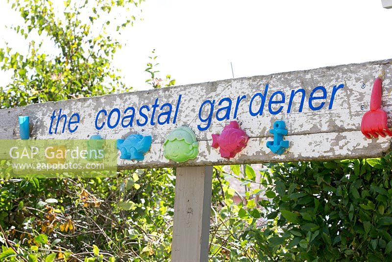 Coastal Gardener sign with reclaimed material from the beach